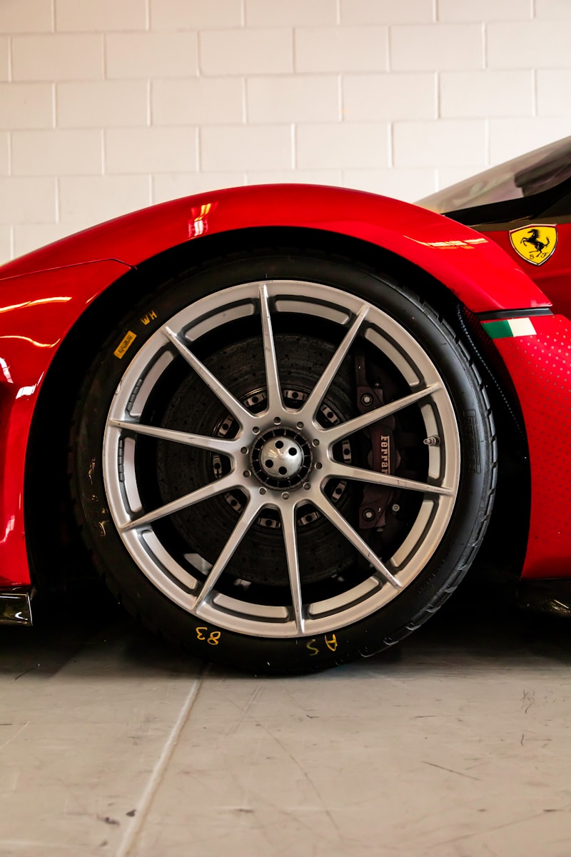 A red sports car parked in a garage